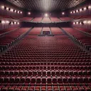 Create a detailed image of a movie theatre interior. The theatre is filled with numerous rows of plush, dark red seats stretching out in precise, uniform layout. There are about 50 to 60 rows with around 20 to 30 seats in each row. Don't include any text or numbers in the image, but capture the vastness of the space, the sea of seats, and the silent anticipation of an empty theatre.